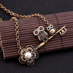 Owls on a flower key pendant necklace.